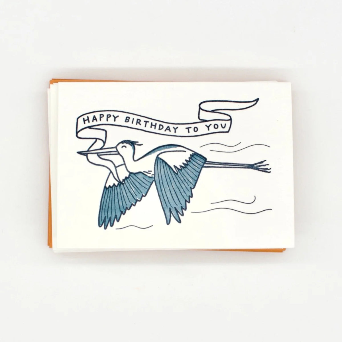 Letterpress card with a great blue heron carrying a birthday banner