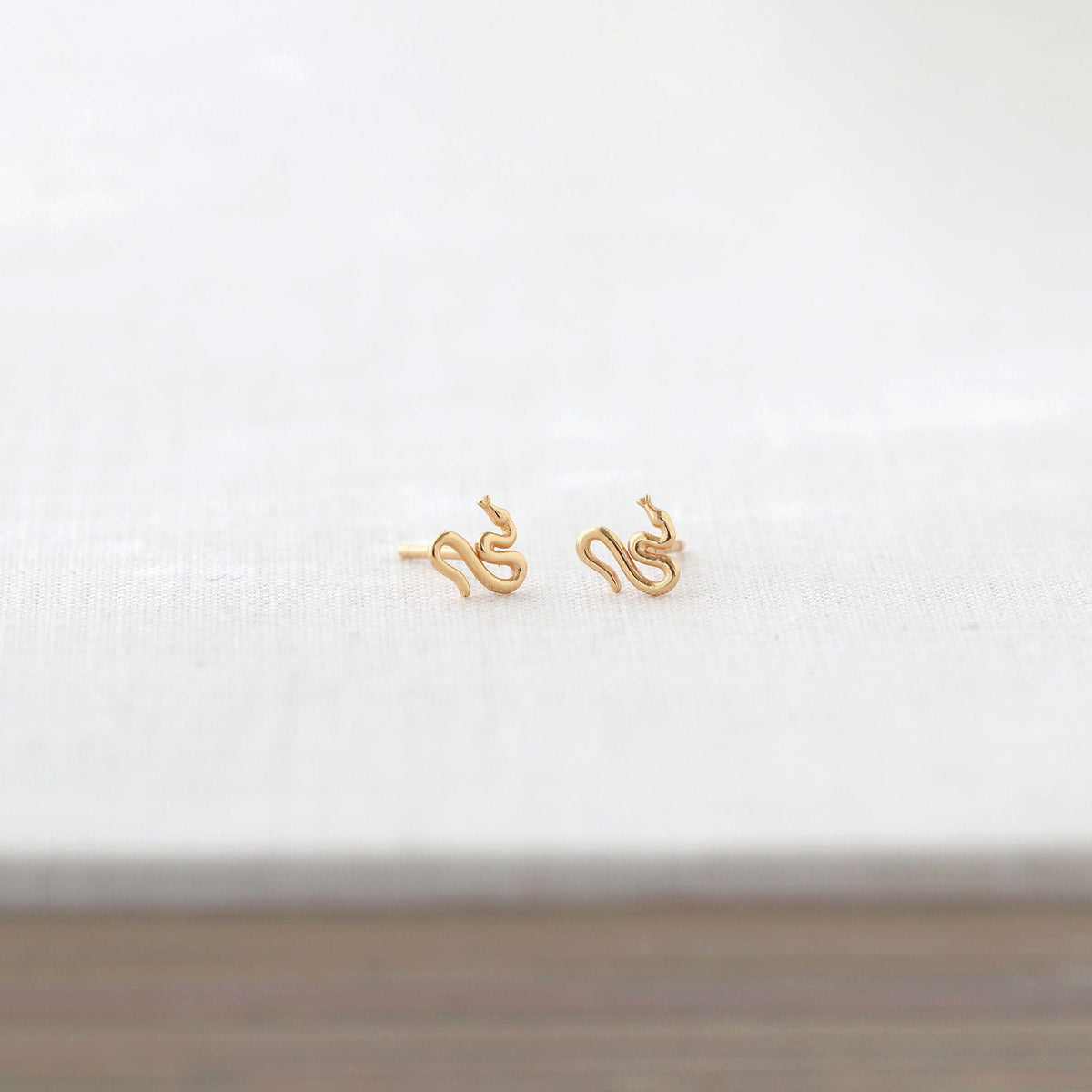 Kris Nations snake stud earrings in 18k gold vermeil